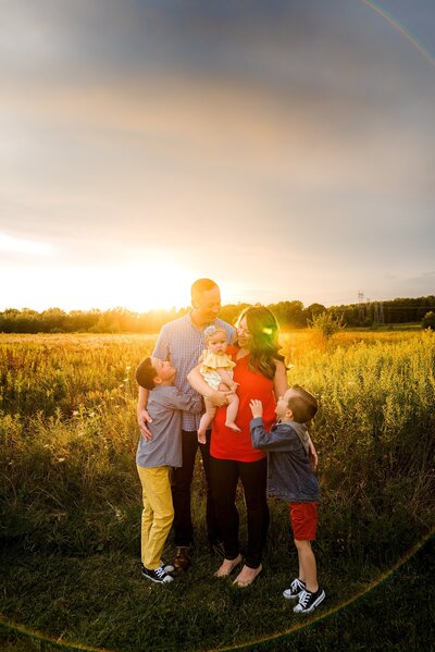 Family in field during goldenhour