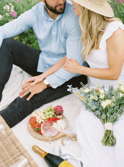 couple holding each other on picnic blanket