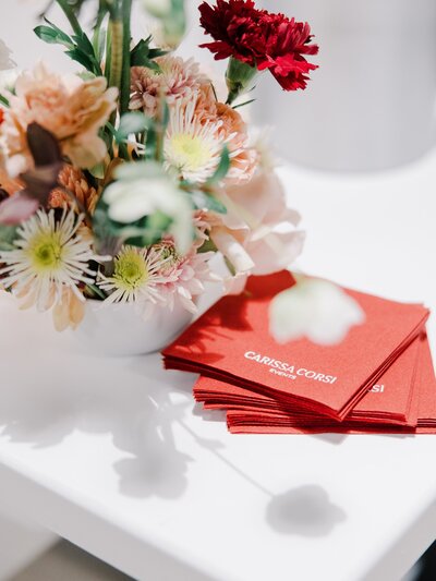 Close up of floral arrangement with custom cocktail napkins