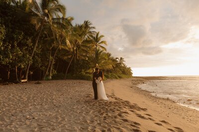 A bride reading her vows to her groom on the beach