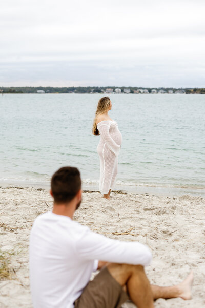 Pregnant woman holding her baby bump on the beach, Wilmington maternity photography