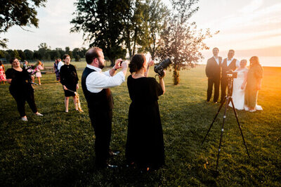 bts image of photographer directing couple at sunset