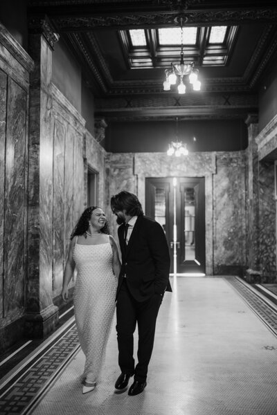 black-white-portrait-of-engaged-couple-in-hotel-lobby-marble-walls-kelly-kaz-upstate-new-york-photographer-buffalo-beyond