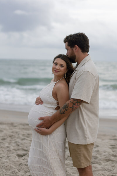 A maternity session as the sun sets, warm taupe and sage tones throughout