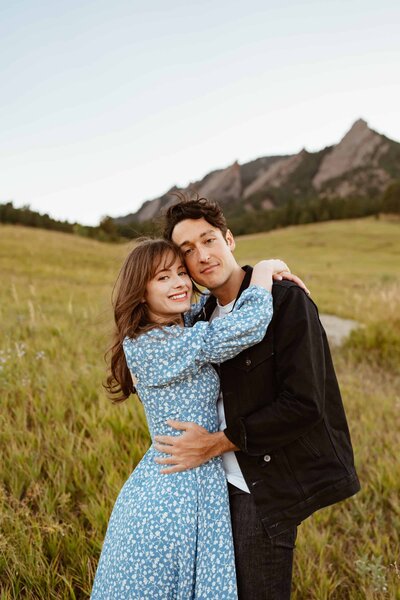 bride and groom in wedding attire  standing in colorado field