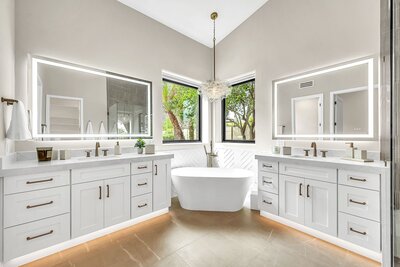 Marble backsplash by Vadara, glass shower, white cabinets