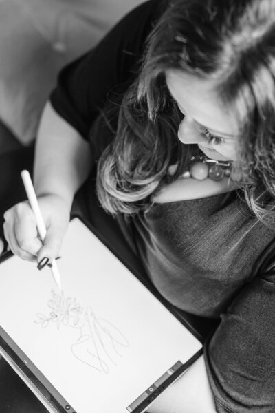 Sarah Shuttle, luxury brand designer, sketching visual concepts on her iPad during the creative process.