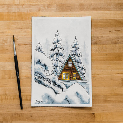 Watercolor painting of a small cabin tucked away in the snowy woods