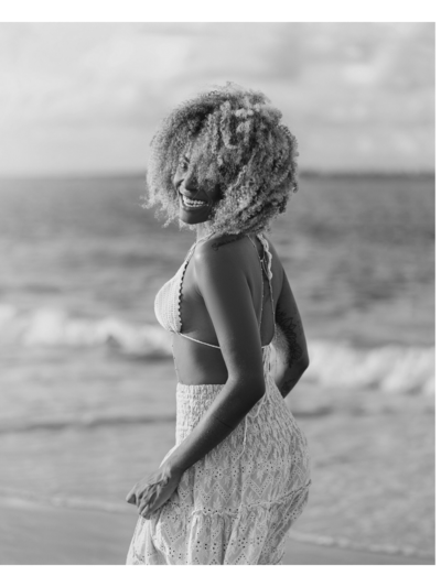 woman in a dress looking out into the ocean