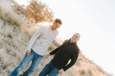 father and son walking in field