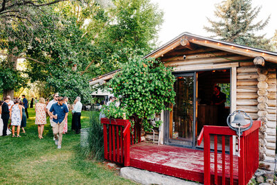 Log cabin with red fence at Shades of Green Events in Helena, MT