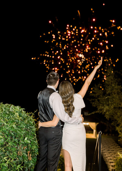 wedding couple watching fireworks on wedding date