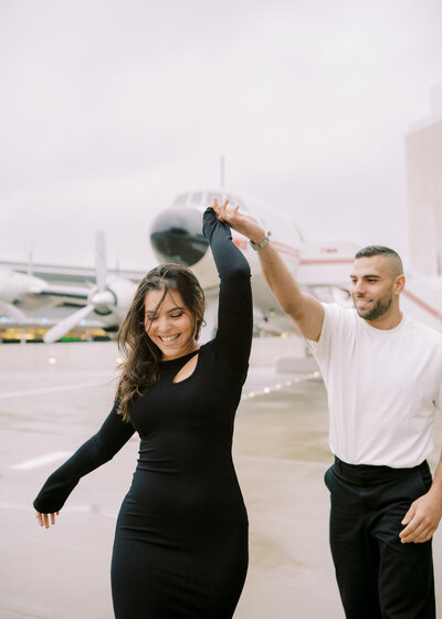 Couple in front of plane at TWA Hotel