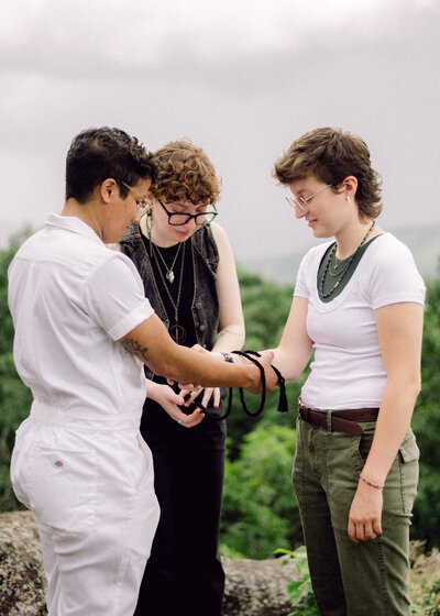 Groom reciting vows as bride looks on, captured in a raw documentary-style moment during elopement