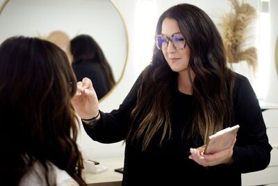 Beauty business coach, Emily Blake, applying bridal makeup to bride.