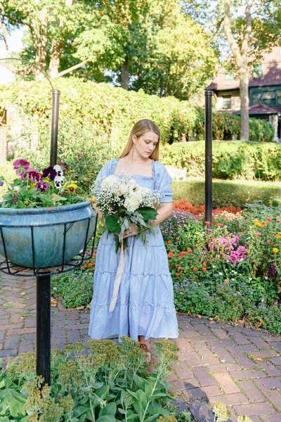 Photo of Katie Whitcomb in an English Garden outside Oliver Mansion