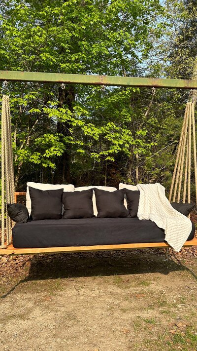 a wooden daybed swing