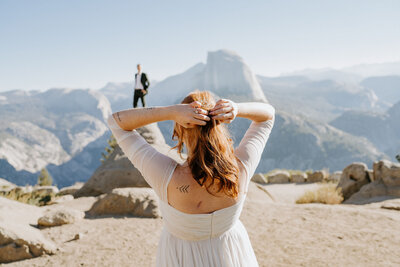 couple at Glacier Point Yosemite looking on at each other on wedding day