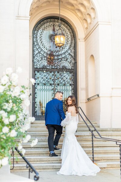 Bride and groom walking up the steps atThe Ebell of Los Angeles Wedding venue.