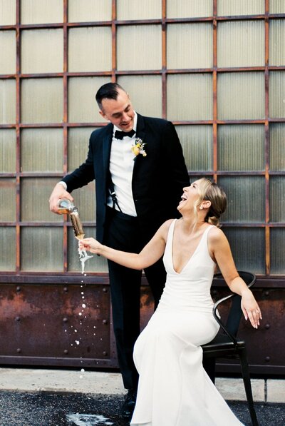 groom pouring bride champagne during wedding portraits