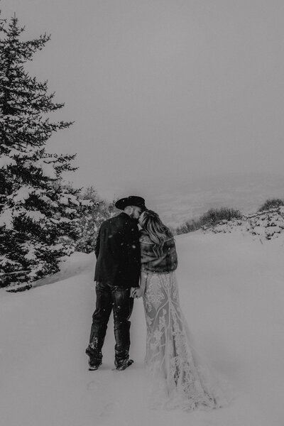 bride and groom kissing in the snowy mountains taken by colorado elopement photographer