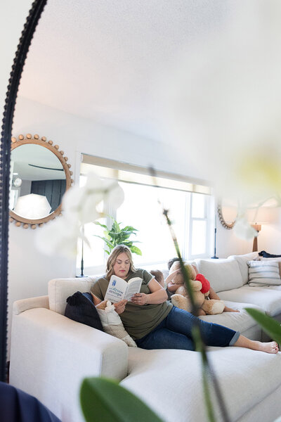 Family sitting on the couch after their living room was professionally cleaned.
