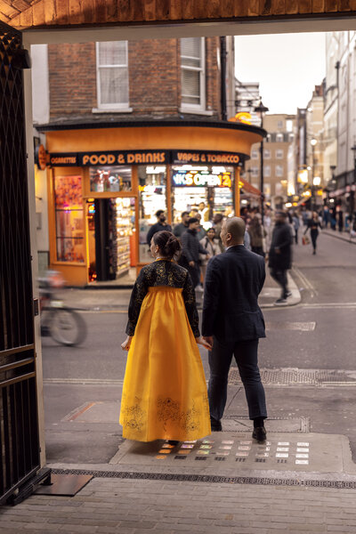 Wedding photographer captures couple taking a stroll hand in hand at their french chateau wedding.