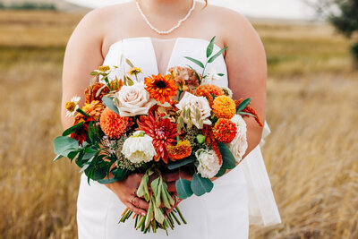 Bride holding large flower bouquet in Choteau, MT
