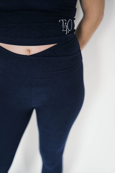 woman wearing navy beyond yoga cross leggings