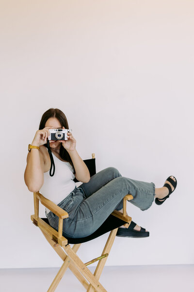 Kylie sitting on steps of college, for grad photos