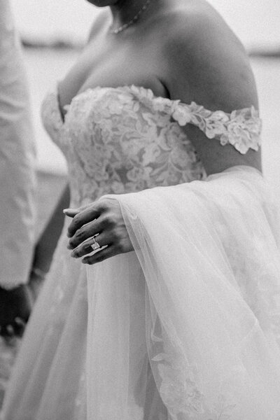 Bride holding her dress walking on the coast in cape cod