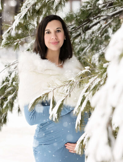Pregnant mom posing for maternity portraits in the snow  in Erie Pa