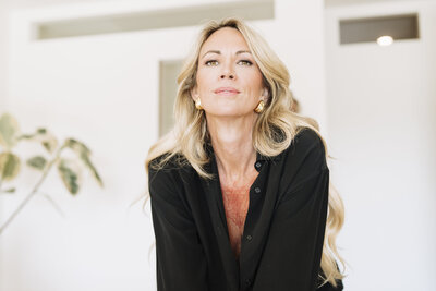 Aine Rock in black button down shirt 