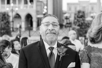 Black and white photo of an emotional father of the groom at Disney's wedding at Epcot