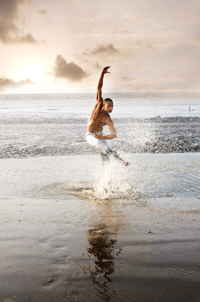 A dancer kicking water as they dance