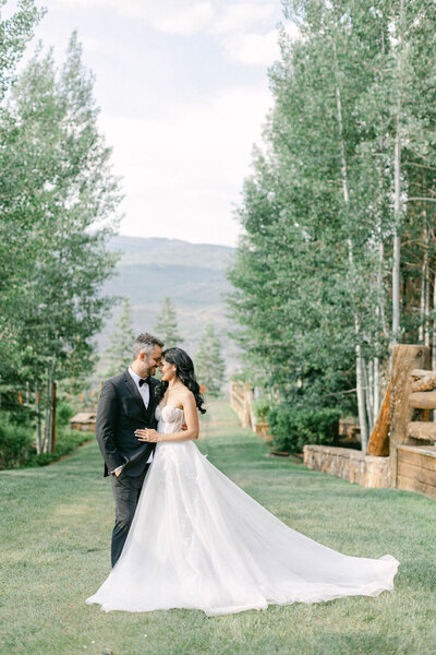 Bride and groom in field at Colorado wedding