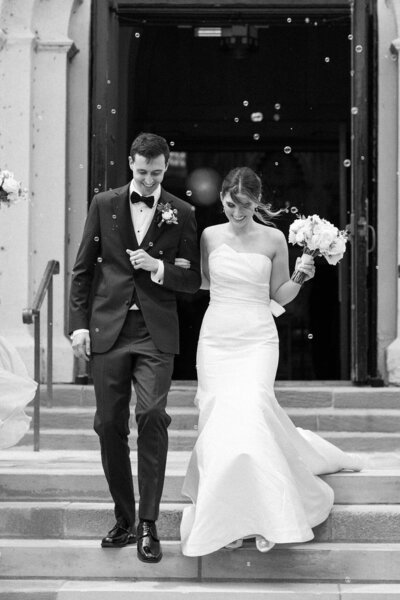 bride and groom walk down steps
