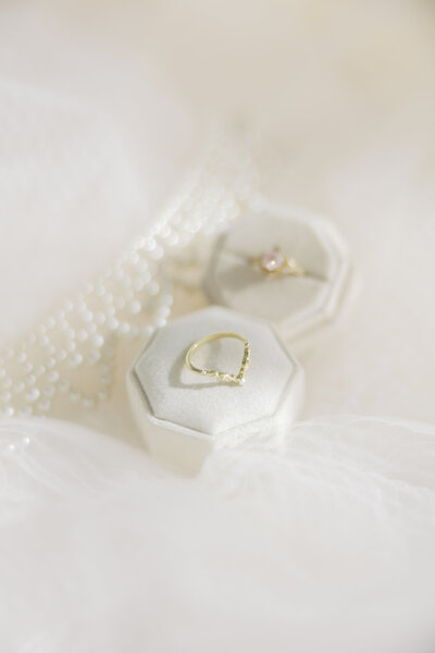 Young woman lying on bed for bridal boudoir photoshoot