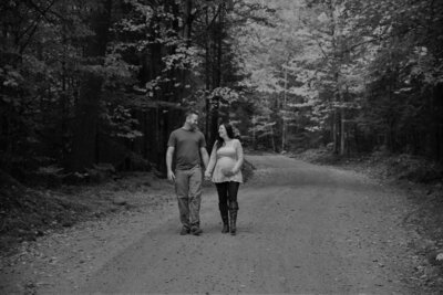 Photo of couple walking down a road | Maternity Session