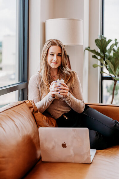woman holding coffee in office