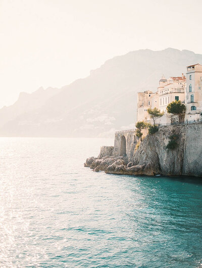 Historic coastal village overlooking the ocean, with buildings cascading down the cliffs.