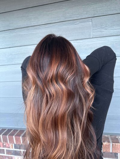 Dimensional brunette with soft waves—representing custom color and lived-in looks at Maven + Grace