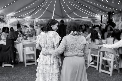 Wedding guests smiling and walking into the reception 