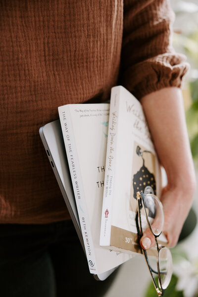 A woman holding website copywriting books