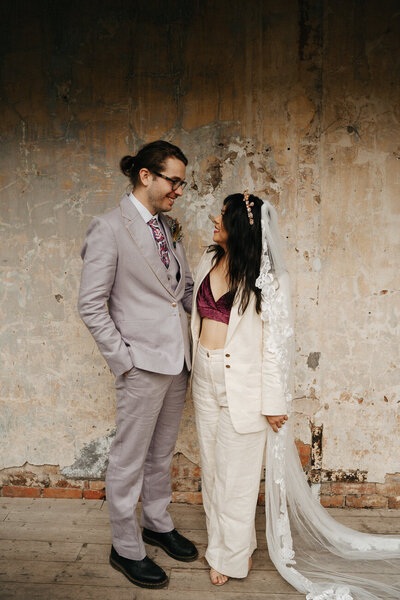 bride and groom snuggling at their collingwood childrens farm ceremony