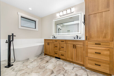 Bathroom design with frameless cabinetry, custom vanity, and contemporary tile selections.