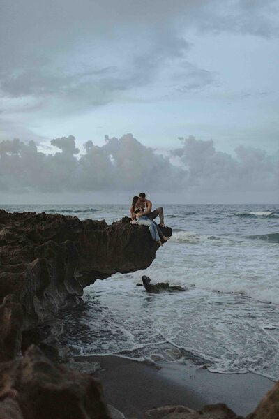 Couple embracing on a cliff by the ocean