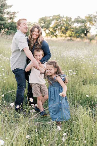 Portland family playing in field at Powell Butte