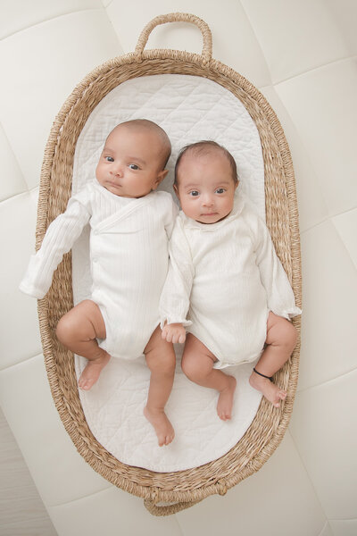 Baby girl sitting in a light green onesie, photographed by Raleigh childrens photographer Christy Johnson