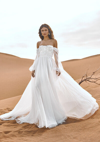 bride wearing a flowy wedding dress in the desert